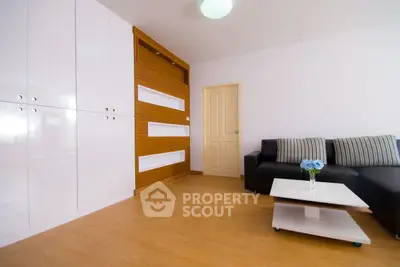 Modern living room with sleek furniture and wooden flooring