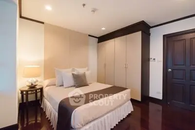 Elegant bedroom with cozy lighting and stylish decor, featuring a comfortable bed and spacious wardrobe.