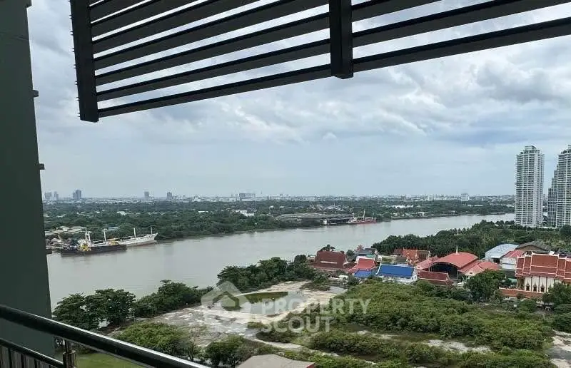 Stunning river view from high-rise balcony with cityscape and lush greenery.