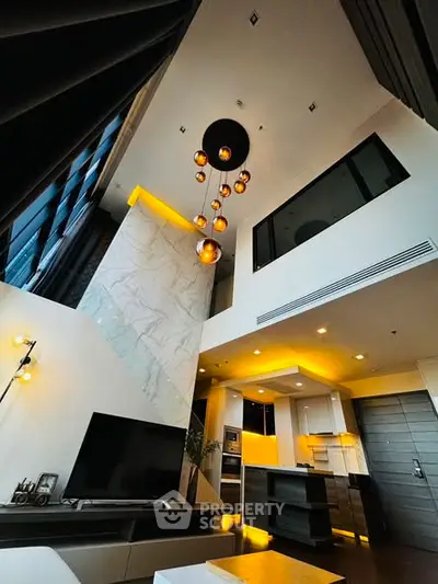Luxurious modern living room with high ceilings and elegant lighting in a stylish apartment.