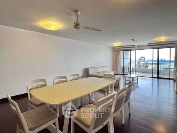Spacious living room with dining area and large windows offering stunning views.