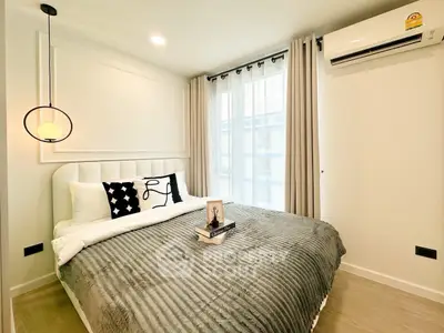 Modern bedroom with stylish decor and natural light