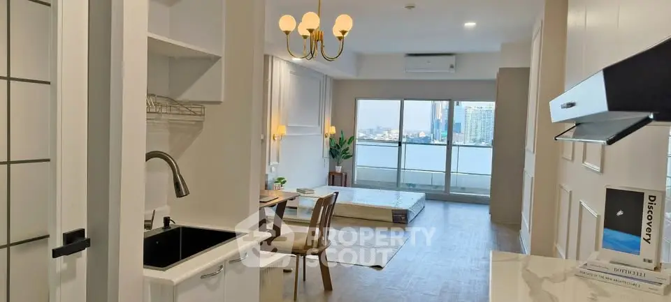 Modern open-layout apartment with city view, featuring stylish kitchen and cozy living area.