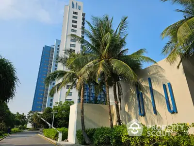 Stunning modern high-rise building with lush palm trees and clear blue sky