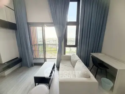 Modern living room with balcony view, featuring sleek furniture and floor-to-ceiling windows.