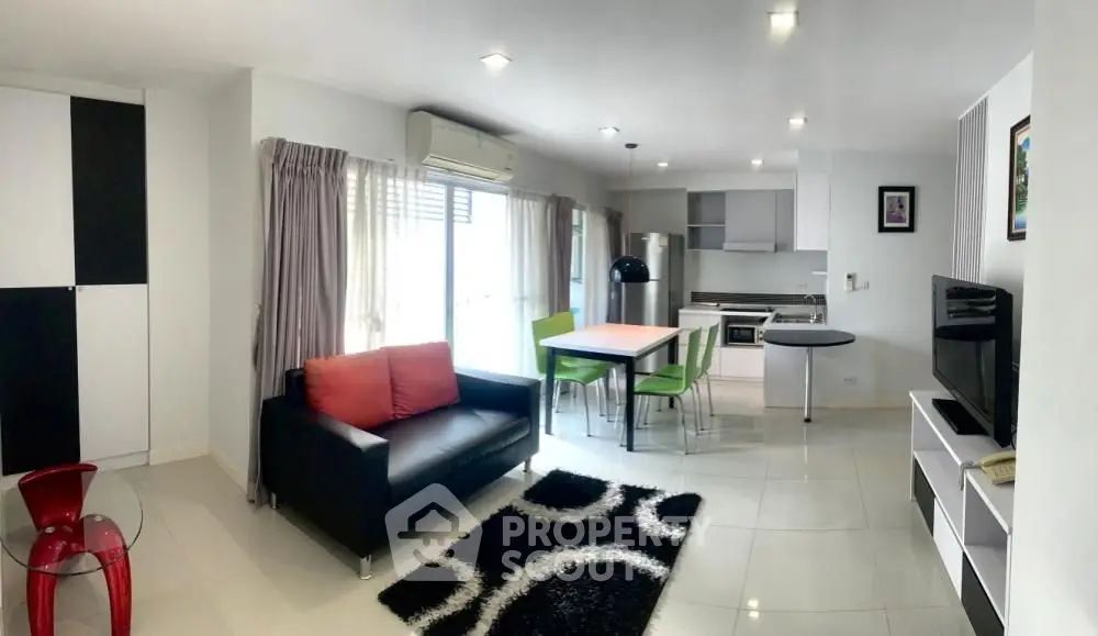 Modern open-plan living room with sleek kitchen and stylish furniture