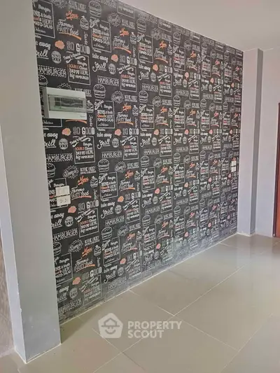 Stylish interior wall with trendy blackboard-style wallpaper in modern apartment.