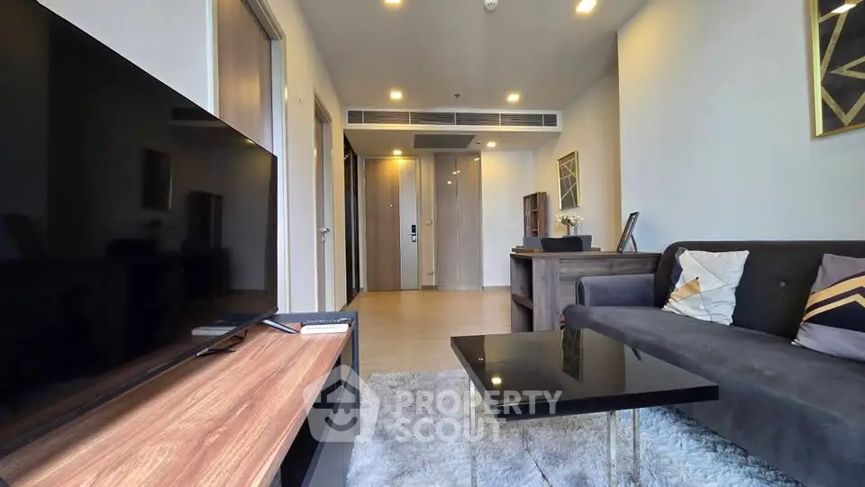 Modern living room with sleek furniture and cozy ambiance in a stylish apartment.