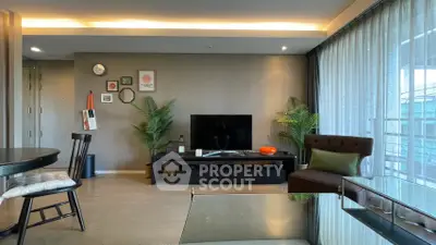 Modern living room with stylish decor and large windows for natural light.