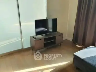 Modern living room with sleek TV stand and flat-screen TV, perfect for entertainment.