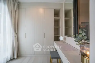 Elegant bedroom with built-in wardrobe and stylish vanity area, featuring soft lighting and modern decor.