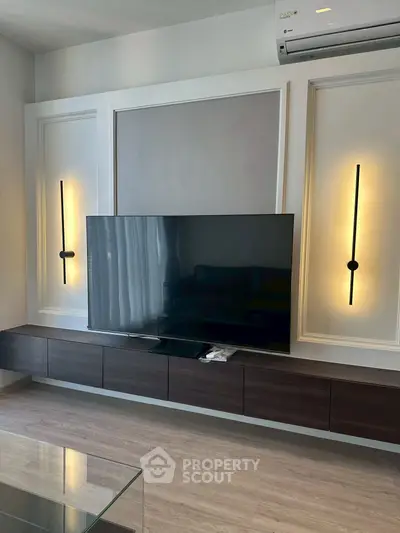Modern living room with sleek TV setup and stylish wall lighting