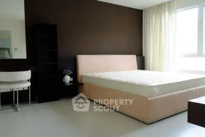 Spacious modern bedroom with large window and elegant furnishings