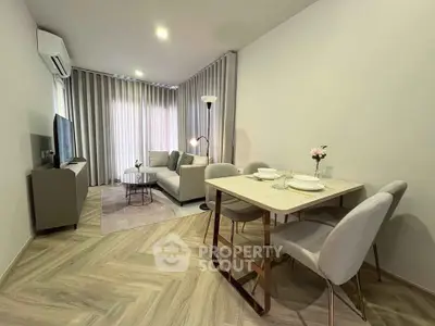 Modern living room with elegant dining area and cozy seating, perfect for relaxation and entertainment.
