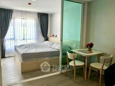 Modern studio apartment with cozy bedroom and dining area, featuring large windows and stylish decor.