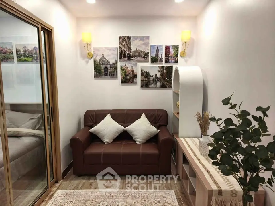 Cozy living room with brown leather sofa, decorative wall art, and modern lighting.
