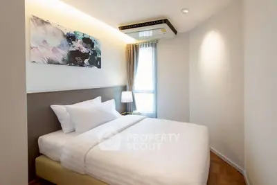 Modern bedroom with stylish decor and natural light in a contemporary apartment.