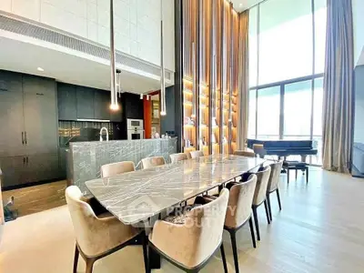 Luxurious dining area with high ceilings and modern design in upscale apartment