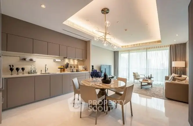 Luxurious open-plan living room and kitchen with modern decor and ample natural light.