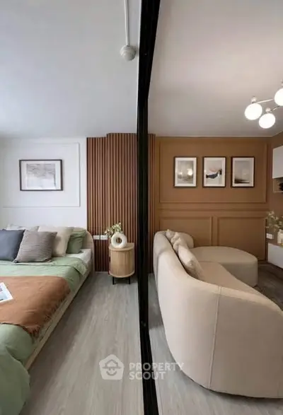Modern open-layout living room and bedroom with stylish decor and cozy ambiance.