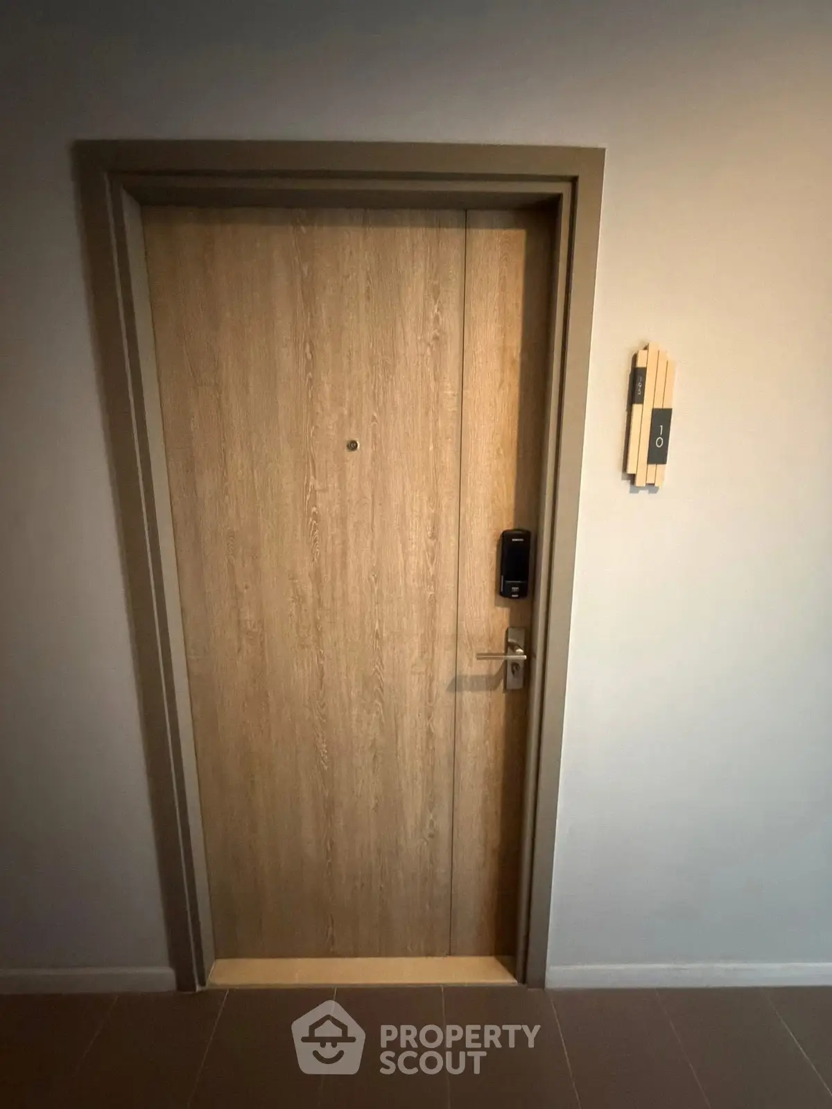 Modern apartment entrance with electronic lock and intercom system.