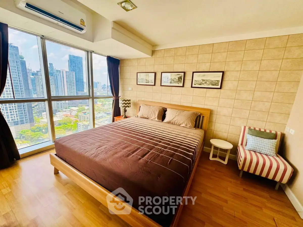 Spacious bedroom with city view in modern high-rise apartment
