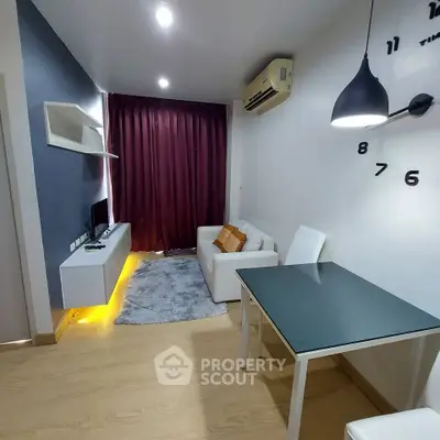Modern living room with sleek furniture and ambient lighting in a cozy apartment.