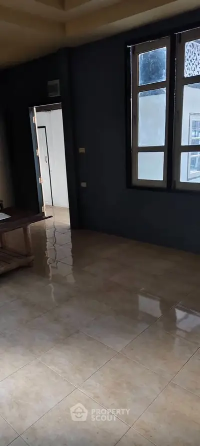 Spacious room with large windows and tiled flooring, perfect for customization.