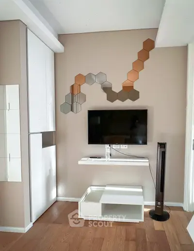 Modern living room with stylish wall decor and sleek TV setup