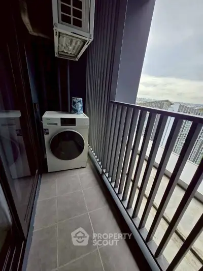 Modern balcony with washing machine and city view, perfect for urban living convenience.