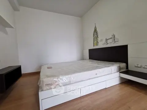 Spacious bedroom with modern design and wooden flooring