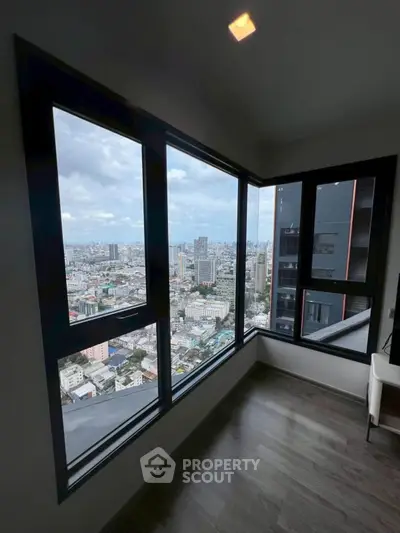 Stunning corner unit with panoramic city views from floor-to-ceiling windows.
