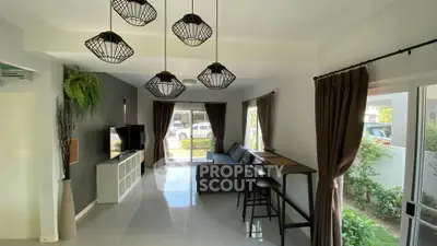 Modern living room with stylish lighting and garden view, featuring sleek furniture and large windows.