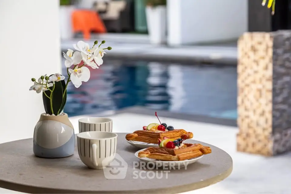 Luxurious poolside breakfast setting with elegant decor and inviting ambiance.