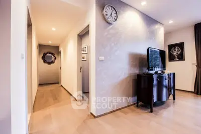 Modern living room with sleek wooden flooring and stylish decor