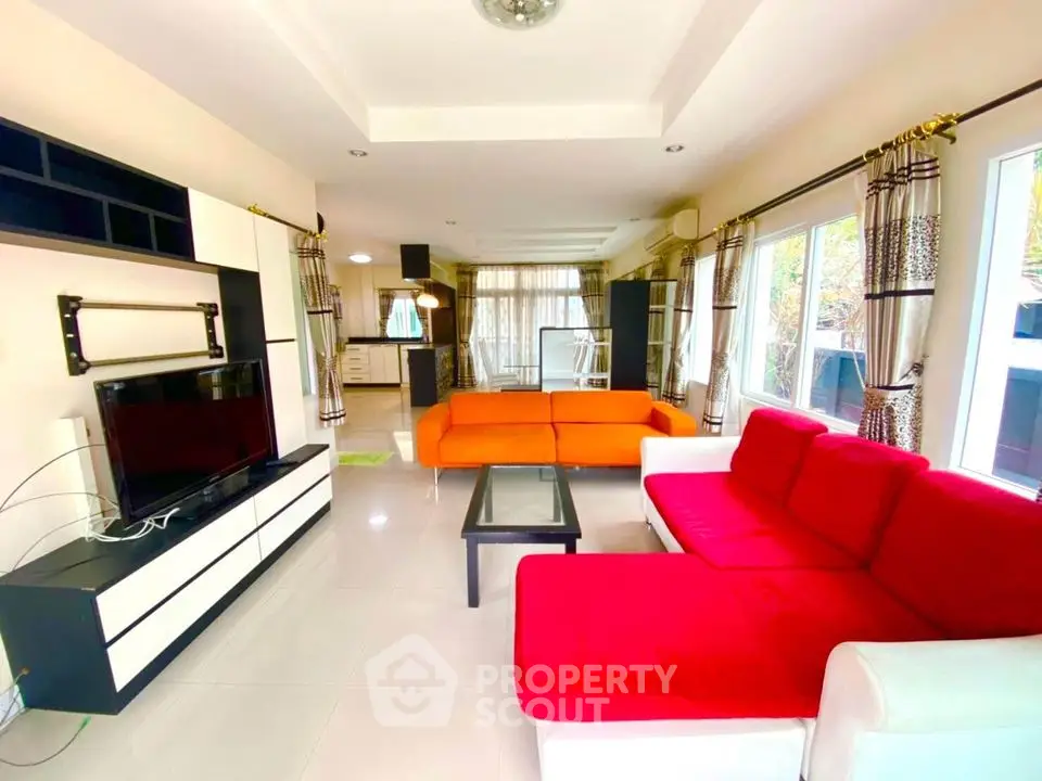 Spacious living room with vibrant sofas and modern decor