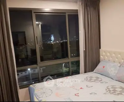 Cozy bedroom with city view, featuring a large window and elegant decor, perfect for urban living.