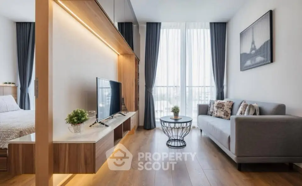 Modern living room with stylish decor and large windows offering natural light.
