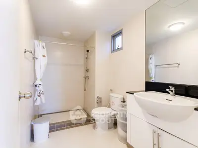 Spacious modern bathroom with sleek fixtures and walk-in shower
