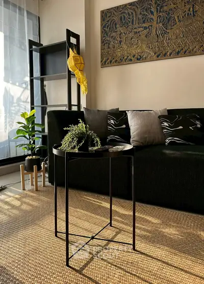 Stylish living room with modern decor, cozy sofa, and elegant artwork, perfect for relaxation.