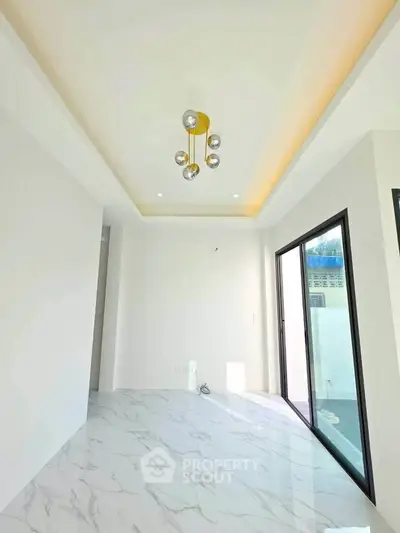 Modern minimalist room with marble flooring and stylish ceiling light fixture.