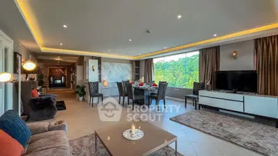 Spacious living room with modern decor and large window offering scenic views