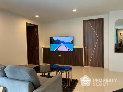 Modern living room with stylish decor and wall-mounted TV