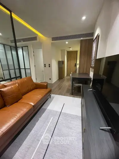Modern living room with leather sofa and sleek TV unit in stylish apartment