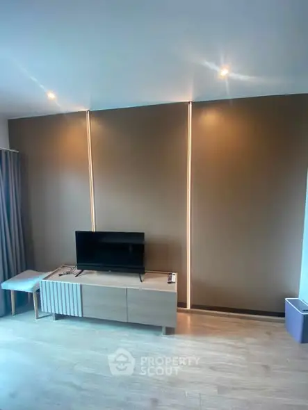 Modern living room with sleek TV stand and ambient lighting