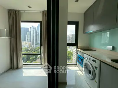 Modern apartment with city view and in-unit laundry, featuring sleek kitchen design.