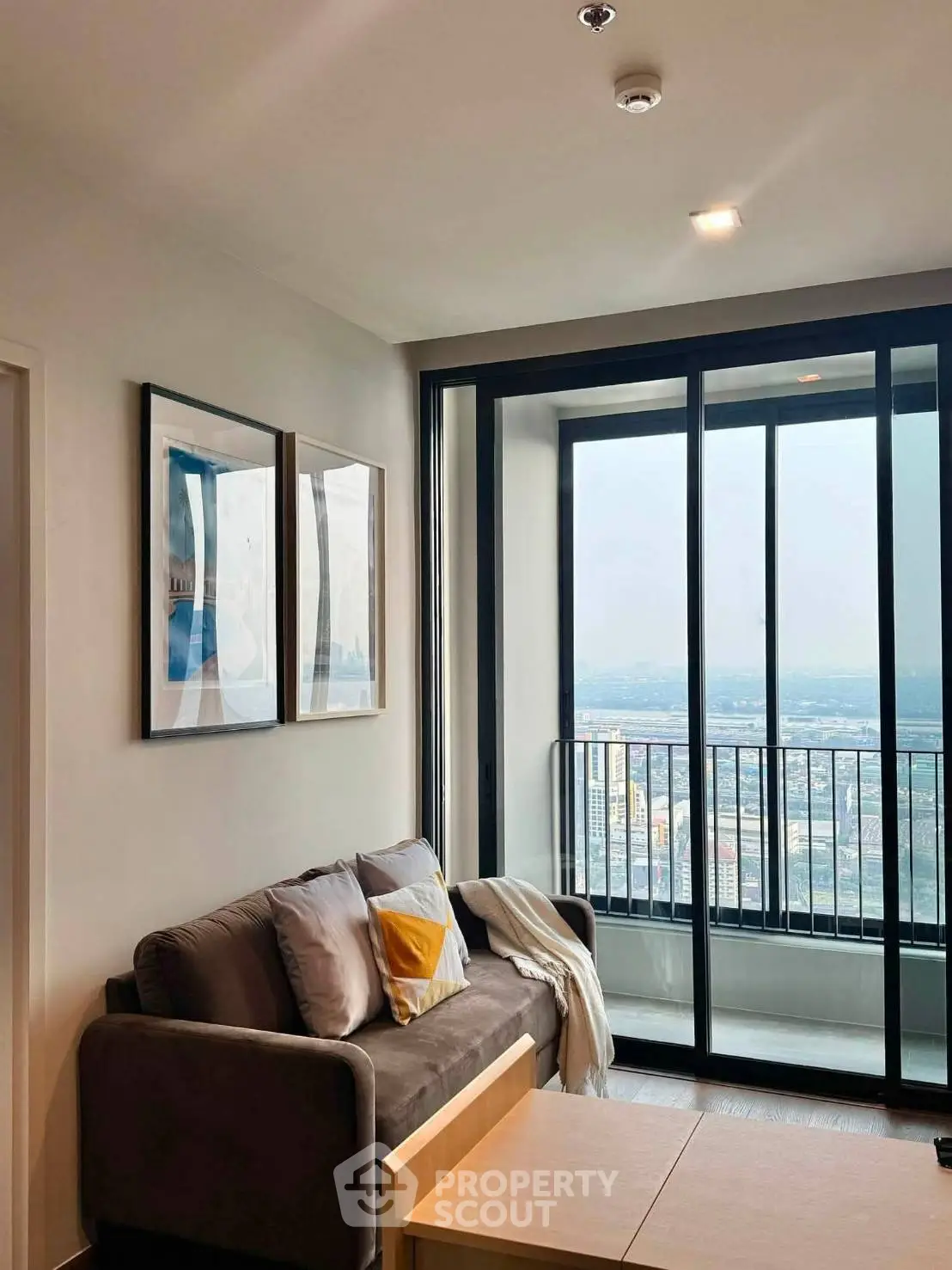 Modern living room with large windows and stunning city view