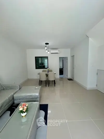 Modern living room with sleek furniture and dining area in open layout