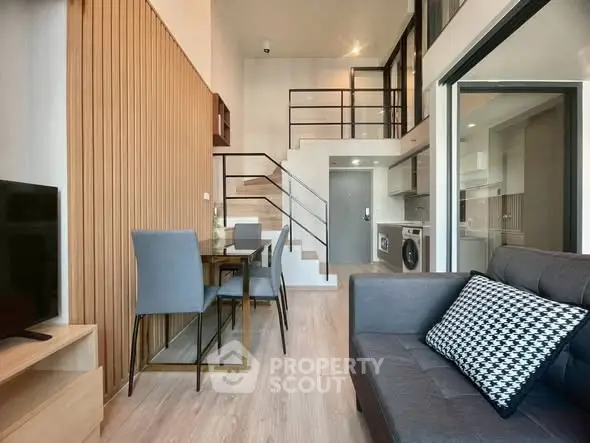 Modern loft apartment with stylish interior, featuring open layout and mezzanine level.