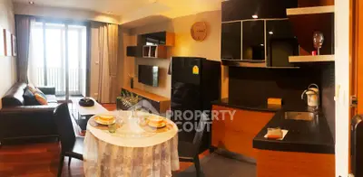 Modern open-plan living room and kitchen with stylish decor and balcony view.